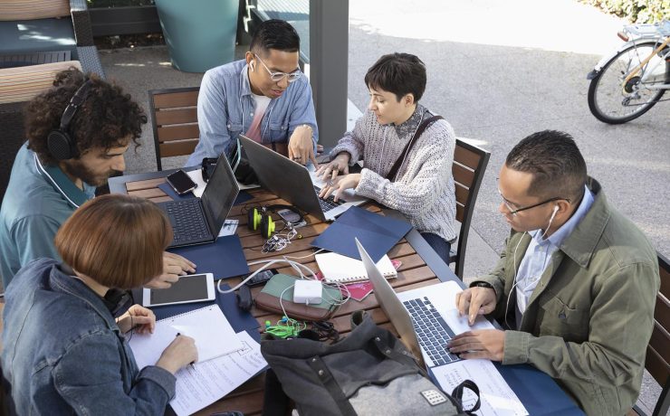 Millennial entrepreneurs working at cafe table